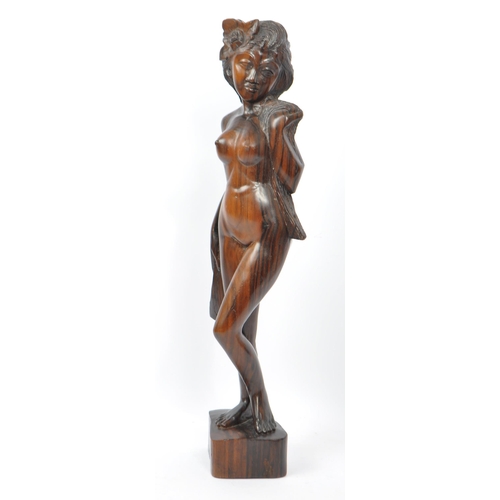 236 - Two vintage 20th century wooden figurines. Consists of a naked Polynesian lady in classic pose, toge... 