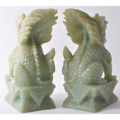 24 - A pair of vintage 20th century jade style green stone Fu foo / temple guard dogs. In a seated postin... 