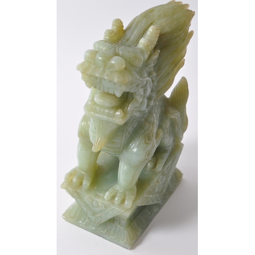 24 - A pair of vintage 20th century jade style green stone Fu foo / temple guard dogs. In a seated postin... 