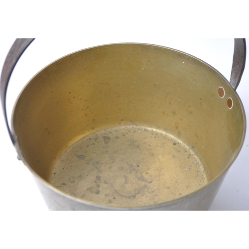 242 - A large 19th Century Victorian brass and copper jam pan with a fixed dome iron carry handle.