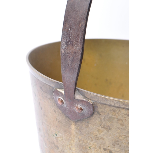 242 - A large 19th Century Victorian brass and copper jam pan with a fixed dome iron carry handle.