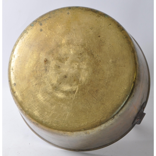 242 - A large 19th Century Victorian brass and copper jam pan with a fixed dome iron carry handle.