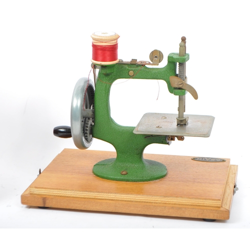 246 - A vintage 20th century cast iron / metal sewing machine by GRAIN. Held within its original wooden la... 