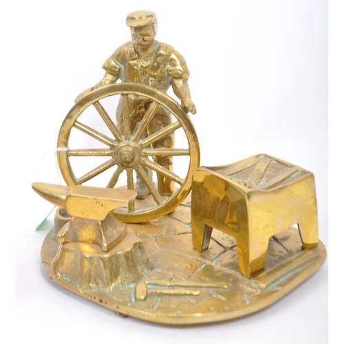 254 - A vintage brass blacksmith's display mounted on a  brass plate base. Display depicts blacksmith stan... 