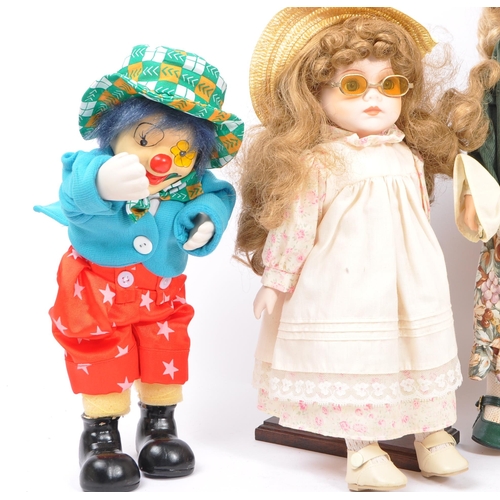 259 - A collection of five assorted collectors porcelain dolls, mainly from the Leonardo Collection & Albe... 