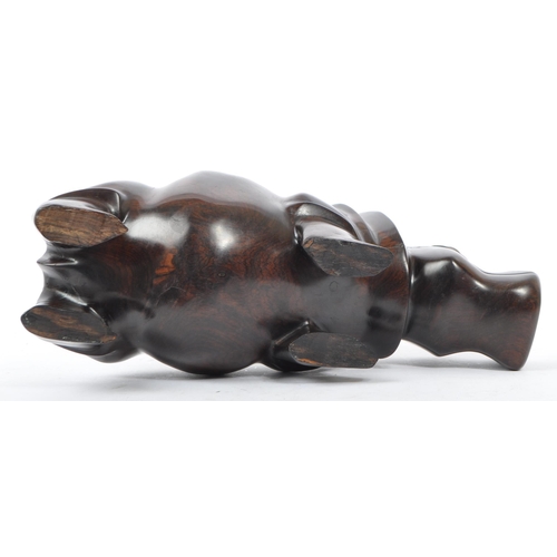 266 - A 20th century African hardwood figure in the form of a hippopotamus having hand carved details inse... 