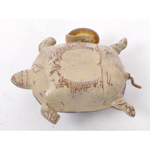 272 - An early 20th century cold painted metal tape measure in the form of a turtle with patterning to bac... 