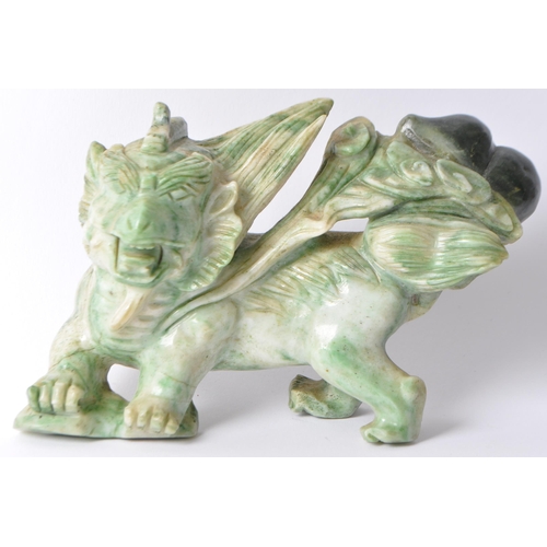 28 - A vintage 20th century Chinese mythological beast green dragon / foo dog / guardian lions. In a stan... 