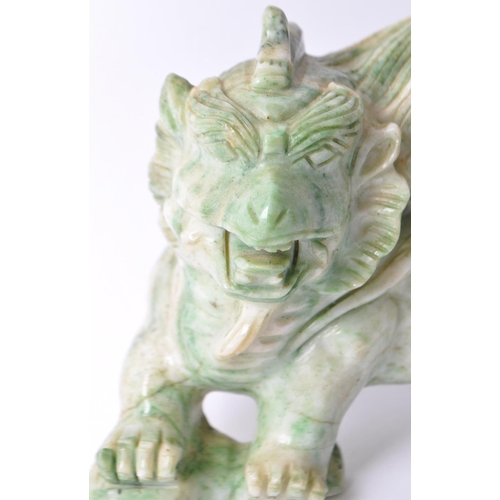 28 - A vintage 20th century Chinese mythological beast green dragon / foo dog / guardian lions. In a stan... 