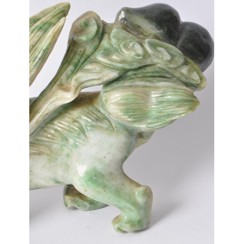 28 - A vintage 20th century Chinese mythological beast green dragon / foo dog / guardian lions. In a stan... 