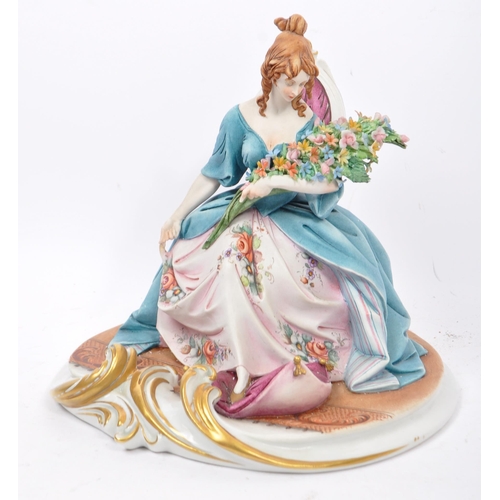 29 - Capodimonte - Italian porcelain china figures. One of a woman with a bouquet of flowers sat in a lad... 