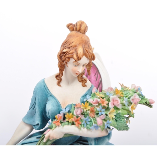 29 - Capodimonte - Italian porcelain china figures. One of a woman with a bouquet of flowers sat in a lad... 