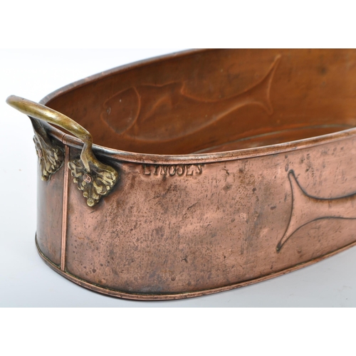 304 - Large vintage copper planter / fish kettle having brass carry handles, depicting stylised fish to ou... 