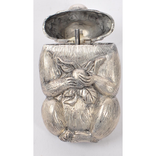 331 - A silver plated vesta case in the form of a monkey. The case having engraved features and being mode... 