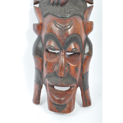 336 - A vintage 20th century carved wood tribal African mask. Of rectangular form with elephant carving to... 