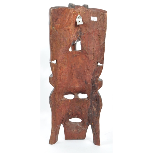 336 - A vintage 20th century carved wood tribal African mask. Of rectangular form with elephant carving to... 