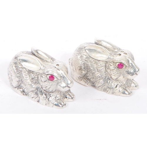 337 - A pair of silver plated condiments in the from of crouching rabbits having engraved features and fac... 