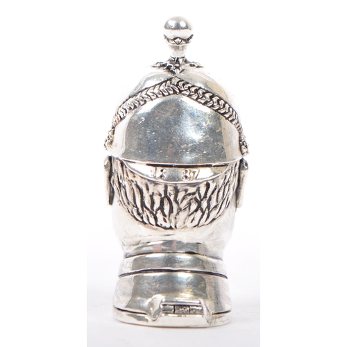 339 - A silver plated vesta case in the form of Victorian policeman wearing a helmet  with moustache. Matc... 