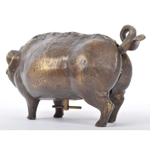 345 - A bronze desk bell in the form of a pig, the underbelly having wind up key with snout and tail influ... 