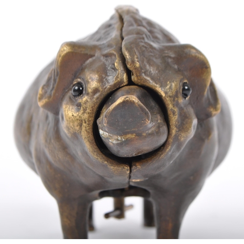 345 - A bronze desk bell in the form of a pig, the underbelly having wind up key with snout and tail influ... 