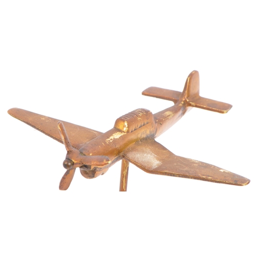 348 - A mid 20th century brass trench art type airplane having articulated propeller and being raised upon... 