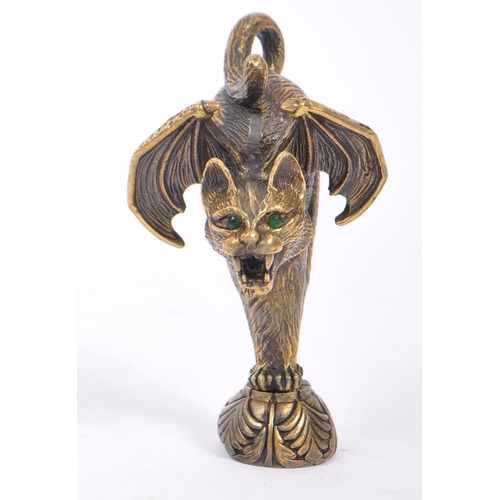 353 - A bronzed metal wax seal in the form of a winged cat modelled with hackles up bearing thangs with fa... 