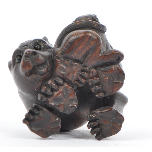 378 - A 20th century Japanese signed carved wood netsuke in the form of a tigress with tiger cub with glas... 