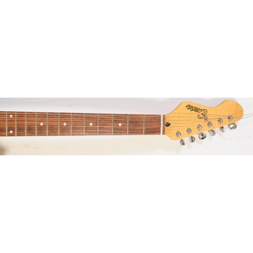 409 - A vintage electric guitar by Encore. Stratocaster style guitar / musical instrument having a black b... 