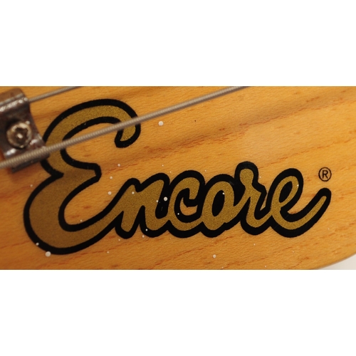 409 - A vintage electric guitar by Encore. Stratocaster style guitar / musical instrument having a black b... 