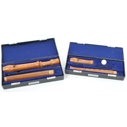 413 - Musical Instruments:  2 Dolmetsch recorders. Each cased in travel cases of black plastic constructio... 