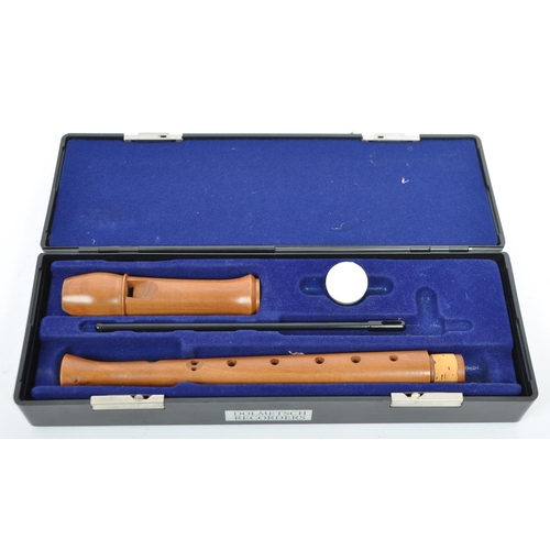 413 - Musical Instruments:  2 Dolmetsch recorders. Each cased in travel cases of black plastic constructio... 