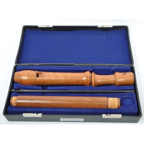 413 - Musical Instruments:  2 Dolmetsch recorders. Each cased in travel cases of black plastic constructio... 