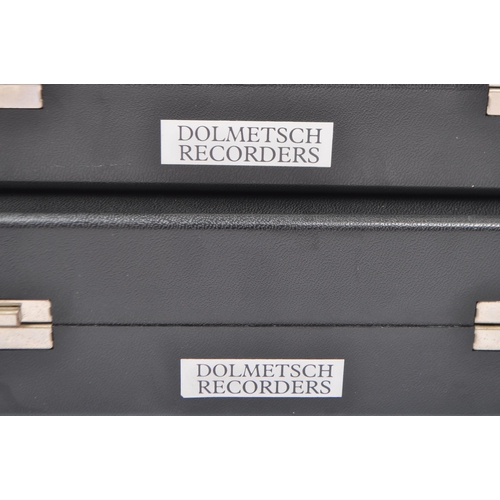 413 - Musical Instruments:  2 Dolmetsch recorders. Each cased in travel cases of black plastic constructio... 