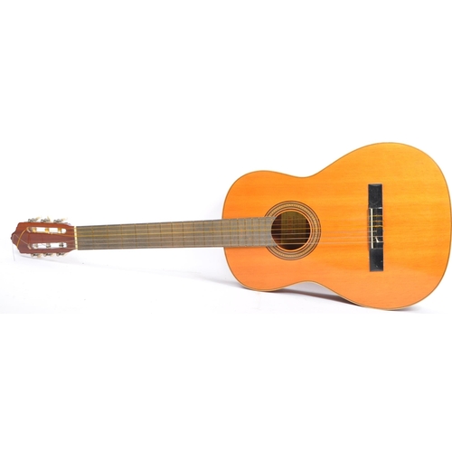 419 - A 20th century Spanish acoustic guitar having inlay to the sound hole and body edge. Within a tan ca... 