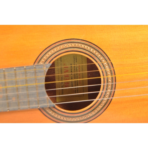 419 - A 20th century Spanish acoustic guitar having inlay to the sound hole and body edge. Within a tan ca... 