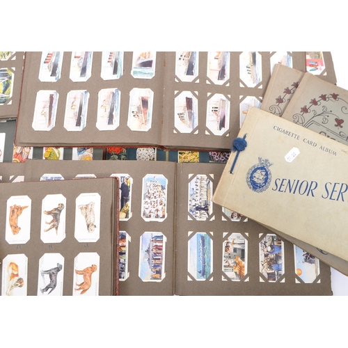 450 - A large collection of vintage 20th century cigarette cards. All collection and displayed over albums... 