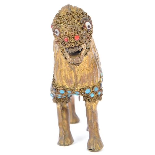 281 - A 20th century vintage Nepalese / Tibetan gilt brass lion is adorned with filigree work to its head ... 