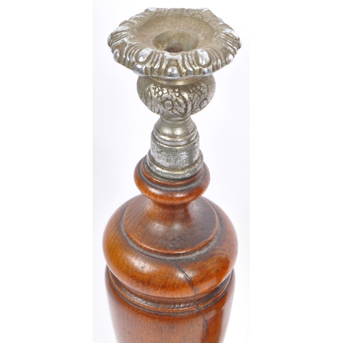 282 - A pair of early 20th century turned wood and silver candlesticks. The candlesticks having ornate sil... 