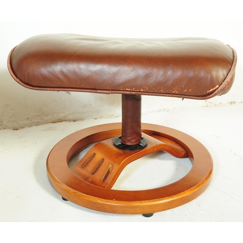 599 - A retro mid 20th century Ekornes stressless style reclining swivel armchair. Having a rectangular cu... 