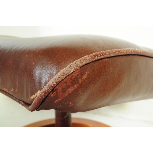 599 - A retro mid 20th century Ekornes stressless style reclining swivel armchair. Having a rectangular cu... 