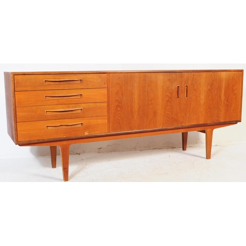601 - Meredew Furniture - A vintage 20th century teak wood sideboard credenza. Of rectangular shape with a... 