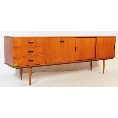602 - British Modern Design - Vintage 20th century teak sideboard credenza. Of rectangular form with a ban... 