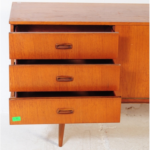 602 - British Modern Design - Vintage 20th century teak sideboard credenza. Of rectangular form with a ban... 