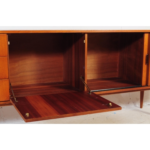 602 - British Modern Design - Vintage 20th century teak sideboard credenza. Of rectangular form with a ban... 