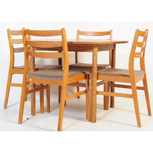 603 - A retro mid 20th century teak dining table with chairs. The table of circular form with round suppor... 