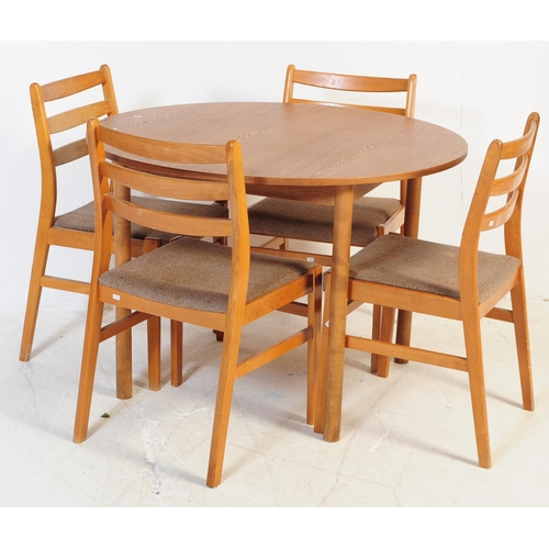 603 - A retro mid 20th century teak dining table with chairs. The table of circular form with round suppor... 