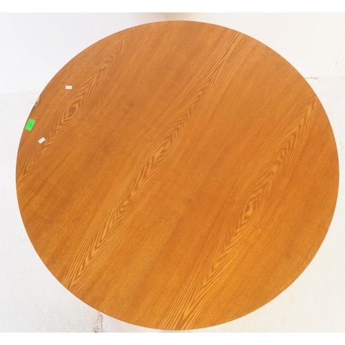 603 - A retro mid 20th century teak dining table with chairs. The table of circular form with round suppor... 