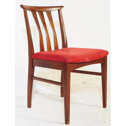614 - A set of four mid 20th century teak Danish inspired dining chairs. Each having shaped top rails over... 