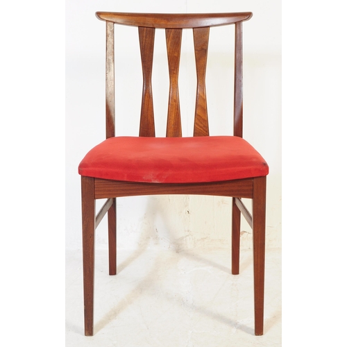 614 - A set of four mid 20th century teak Danish inspired dining chairs. Each having shaped top rails over... 