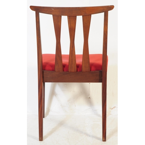 614 - A set of four mid 20th century teak Danish inspired dining chairs. Each having shaped top rails over... 